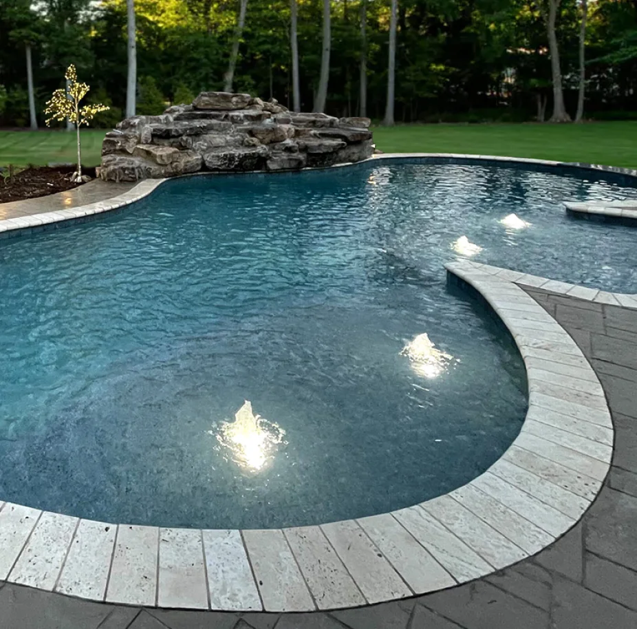 Swimming pool with stone waterfall